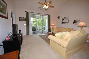 a living room with a couch and a ceiling fan at 1633 Ironwood Condo in Myrtle Beach