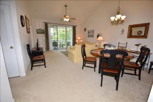 a living room with a table and chairs and a couch at 1633 Ironwood Condo in Myrtle Beach