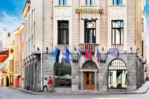 a building with flags on the front of it at Hestia Hotel Barons Old Town in Tallinn