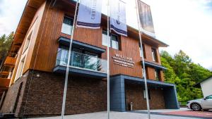 a building with a sign on the side of it at WILLIAM Congress&Wellness Mountain HOTEL **** in Deštné v Orlických horách