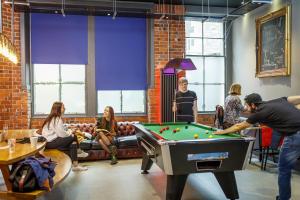a group of people in a room with a pool table at Kick Ass Greyfriars (18+) in Edinburgh