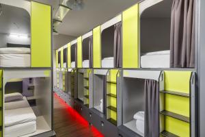 a room with yellow and gray bunk beds at Kick Ass Grassmarket (18+) in Edinburgh