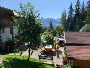 a patio with a table and chairs in a yard at Haus Latschenheim in Ramsau am Dachstein