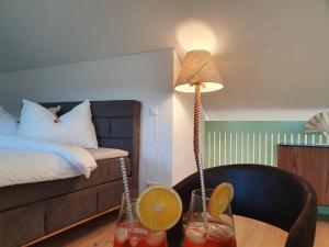 a room with a bed and a table with a lamp at Wohnstation President Suite in Subingen