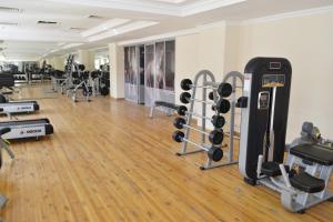 a gym with lots of treadmills and weights at Pakhtakor Athletics hotel in Tashkent