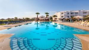 a large swimming pool with blue water in a resort at Hotel Nour Congress & Resort in Bizerte