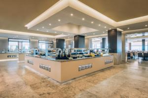 a large kitchen with a counter in a room at Iberostar Selection Kuriat Palace in Monastir
