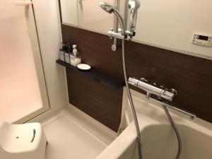 a bathroom with a shower and a toilet at Local Hakata apartment No9 in Fukuoka