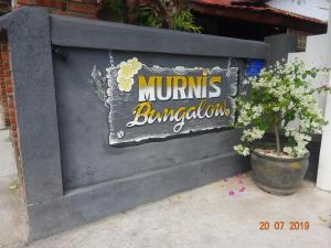 a sign for a tumulus bulding at Murnis Bungalow in Lovina