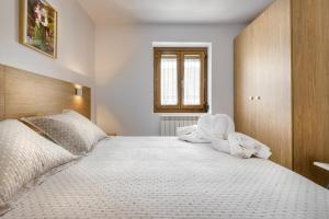 A bed or beds in a room at Casa Marosa