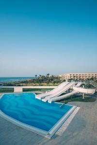 a swimming pool with a slide next to a resort at Iberostar Selection Kuriat Palace in Monastir