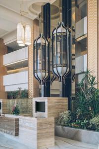 a lobby of a building with three large glass chandeliers at Iberostar Selection Kuriat Palace in Monastir