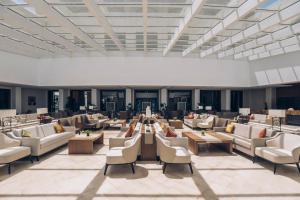 a large lobby with couches and tables and chairs at Iberostar Selection Kuriat Palace in Monastir