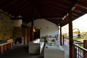 a living room with a couch and a fireplace at To Kastri in Kalopanayiotis
