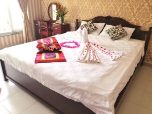 Postel nebo postele na pokoji v ubytování Nathalie's Vung Tau Hotel