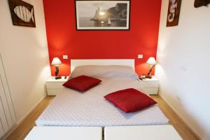 1 dormitorio con paredes rojas y 1 cama con 2 almohadas rojas en Lo Zione, en Arcola