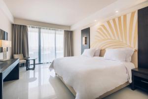 a hotel room with a large bed and a desk at Iberostar Selection Kuriat Palace in Monastir