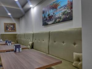 a waiting room with a couch and a table at Grand Hekimoğlu HOTELS in İzmir