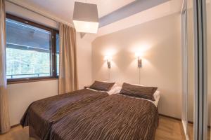 Postel nebo postele na pokoji v ubytování Villa Ylläs 301