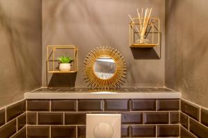 a bathroom with a mirror and a sink at L Her Beau d Hier in LʼÉpine +28 photos