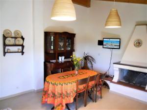 a dining room with a table and a television at Casa Anselmi in Portoferraio