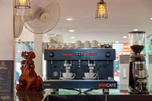 a coffee shop with a blue espresso machine on display at Blossoming Romduol Boutique in Siem Reap