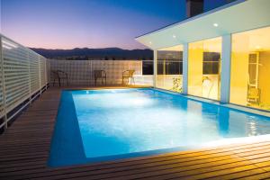 a swimming pool on the roof of a building at Urbana Class Hotel in Mendoza