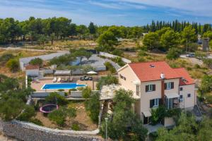 an aerial view of a house with a swimming pool at Villa Bravura Milna Brac in Milna