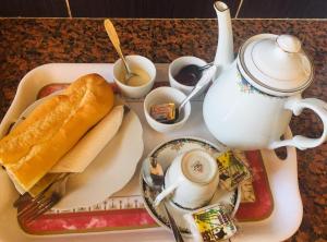 a tray with a hot dog and a tea pot at HOTEL MENABE in Morondava