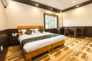 a bedroom with a bed and a desk and a table at Hotel Buddha House Himalayan Brothers in Dharamshala +71 photos