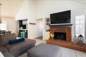 a living room with a fireplace with a flat screen tv at Village Bay 1 - V006 in Lake Arrowhead