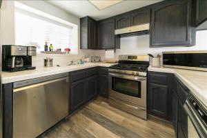 a kitchen with black cabinets and stainless steel appliances at Village Bay 1 - V006 in Lake Arrowhead