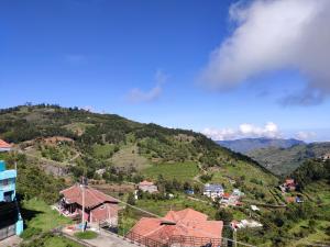 an aerial view of a village on a mountain at Valley Villa in Kodaikānāl