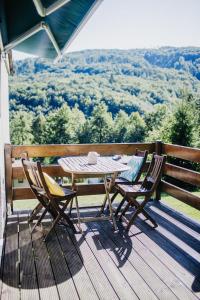a table and two chairs on a deck with a view at U Haliny - Tyra Natura in Třinec
