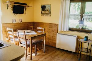 a kitchen with a table and chairs and a television at U Haliny - Tyra Natura in Třinec