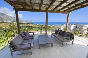 a patio with two chairs and a table at La Blanca Resort & Spa in Castellammare del Golfo