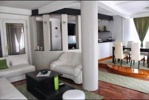 a living room with a white couch and a table at Hotel Fontana in Zenica