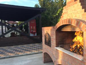 a brick oven with a fire in it at Tango margo in Iaşi