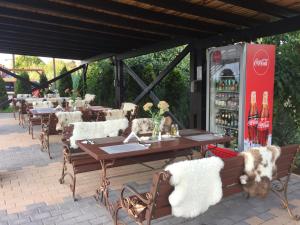 a patio with tables and chairs and a coke machine at Tango margo in Iaşi