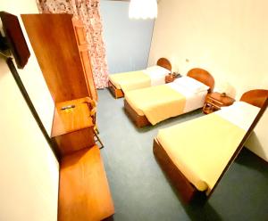 Łóżko lub łóżka w pokoju w obiekcie Hotel Pamela