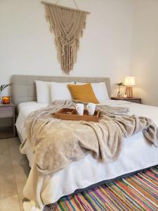 a large bed with a wooden tray on top of it at Luxury 5th Avenue Menesse 32 in Playa del Carmen