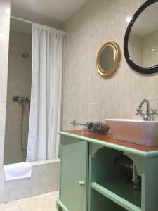 a bathroom with a sink and a mirror and a shower at Apartamentos Villa Nadine in Playa de Palma