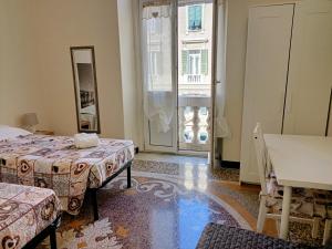 um quarto de hotel com duas camas e um espelho em Affittacamere Monumentale em Gênova
