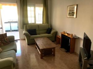 a living room with a couch and a coffee table at PLAYA PARAISO in Playa Honda