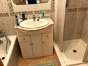 a bathroom with a sink and a shower and a tub at PLAYA PARAISO in Playa Honda