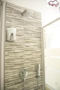 a shower with a shower head in a bathroom at B & B Raffaello in Terzigno +20 photos