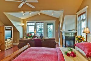 a bedroom with a large bed and a large window at Bonniebrook Lodge in Gibsons