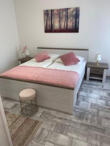 a bedroom with a bed with two pillows and a stool at Mariposa 2 in Bad Harzburg +14 photos