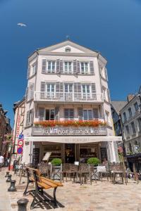 a building with tables and chairs in front of it at Entre Terre Et Mer in Honfleur