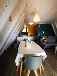 a dining room and living room with a table and chairs at Ferienhaus in der Rhön Sitzmann in Bischofsheim an der Rhön